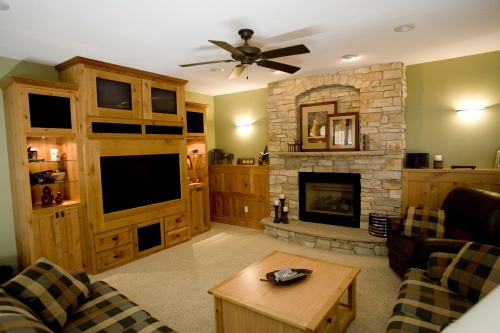 Built-in wood entertainment center and fireplace surround